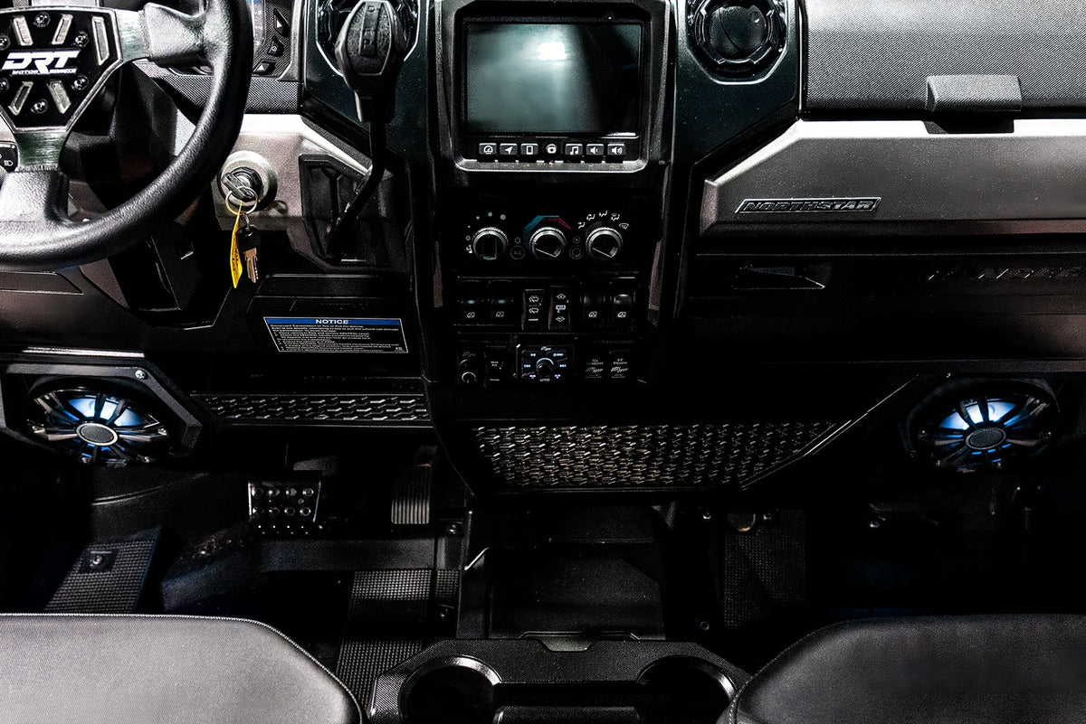 Interior dashboard of a Northstar vehicle with DRT steering wheel and illuminated blue speakers