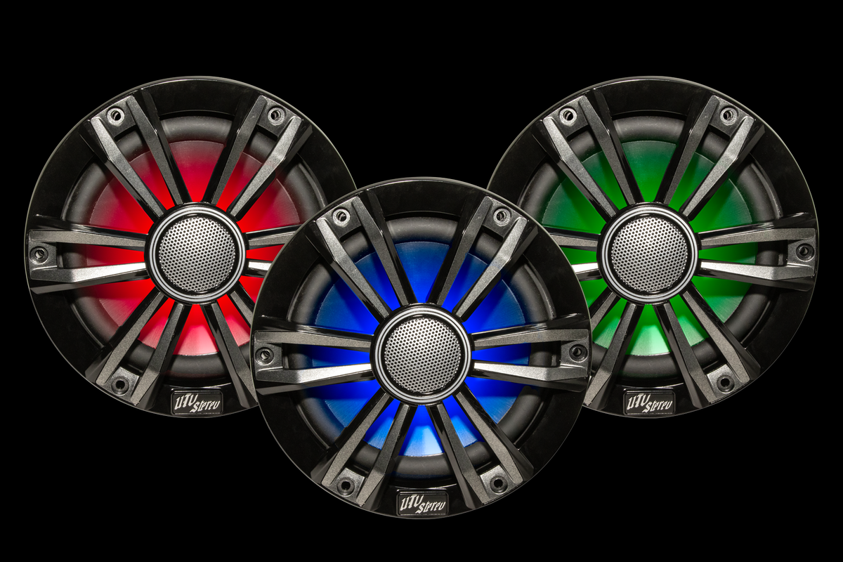 Three car speakers with colorful LED lighting on a black background