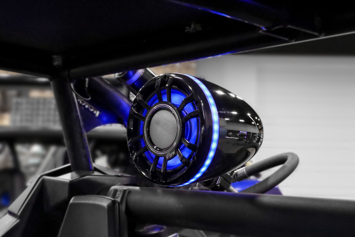 UTV Stereo black wake tower speaker with blue LED ring mounted on roll cage