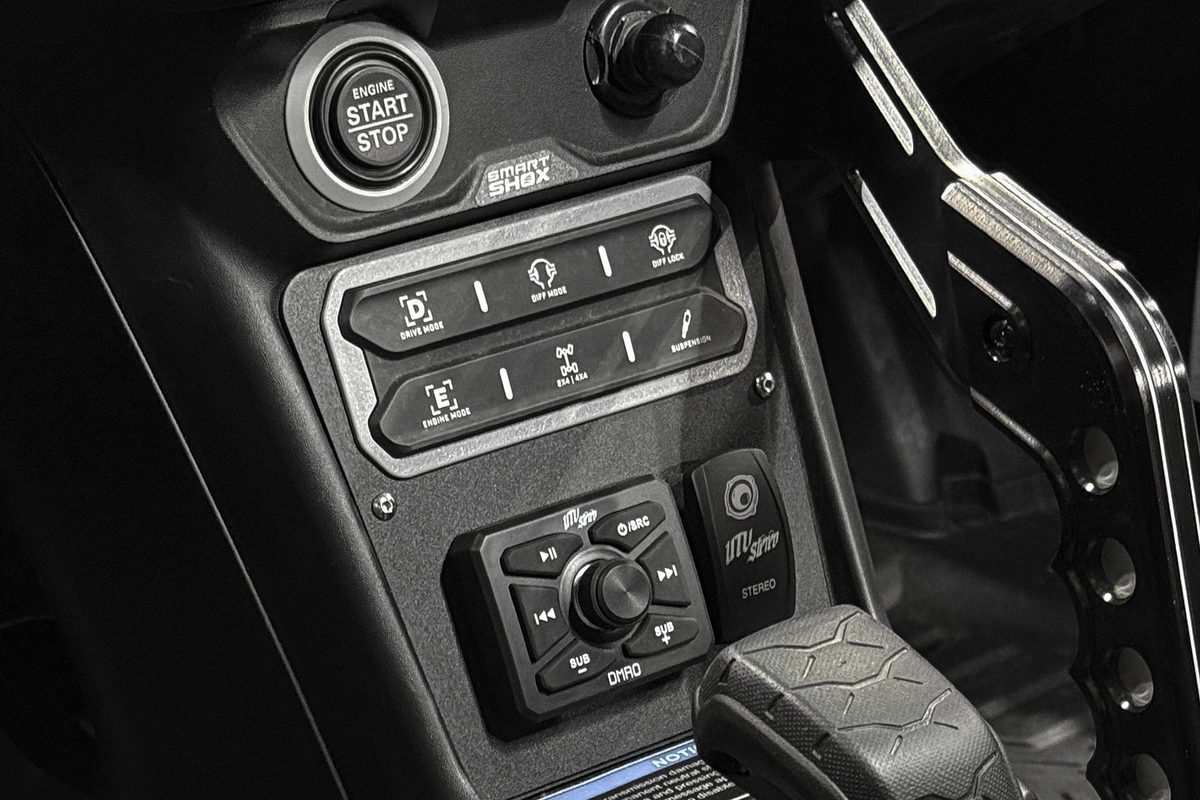 Can-Am vehicle dashboard with engine start button and UTV Stereo audio controls