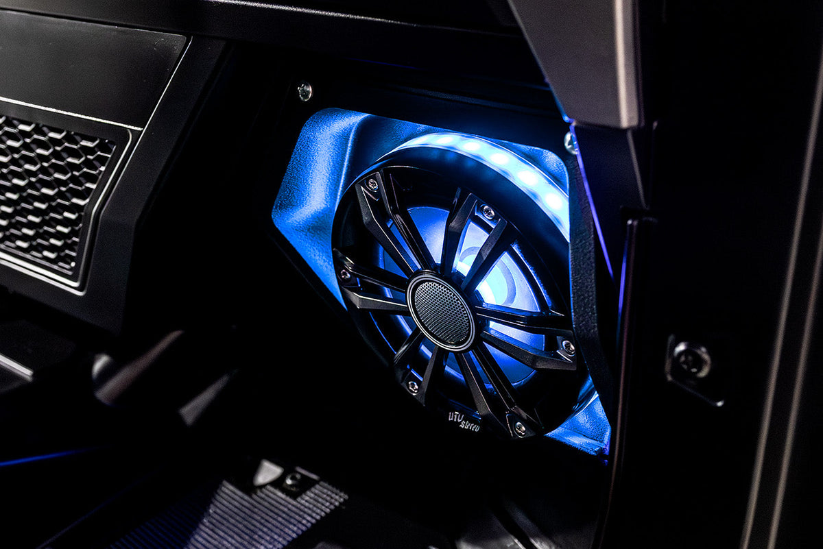 UTV Stereo speaker with blue LED ring lighting installed in a vehicle panel