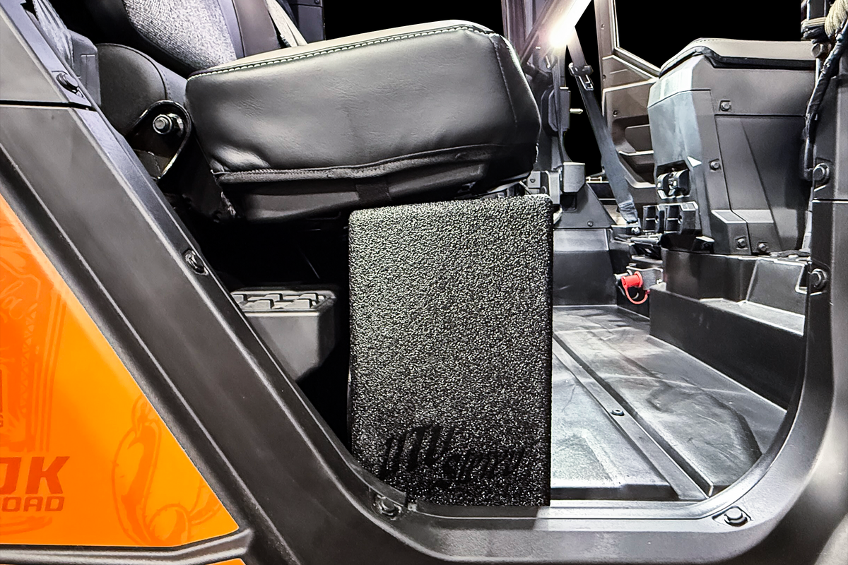 UTV Stereo subwoofer enclosure installed under the seat of a side by side vehicle