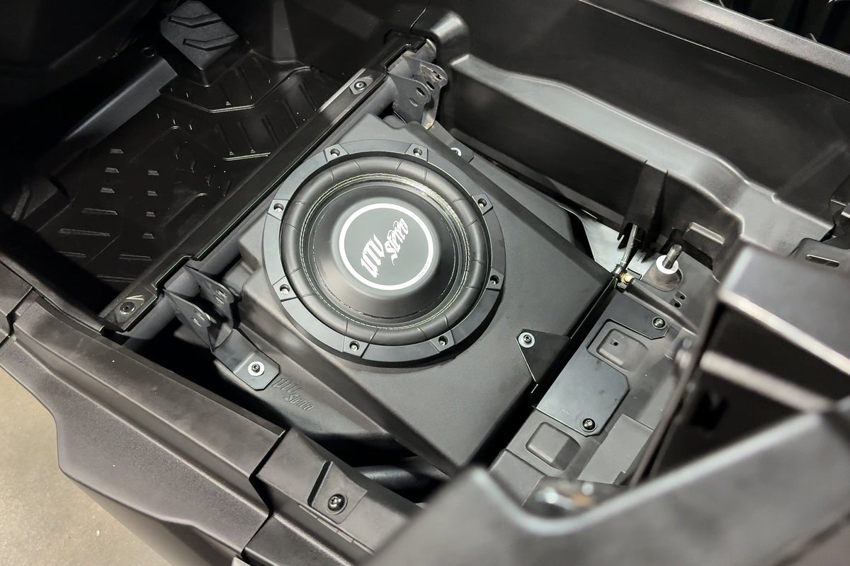 UTV Stereo subwoofer installed in a vehicle storage compartment
