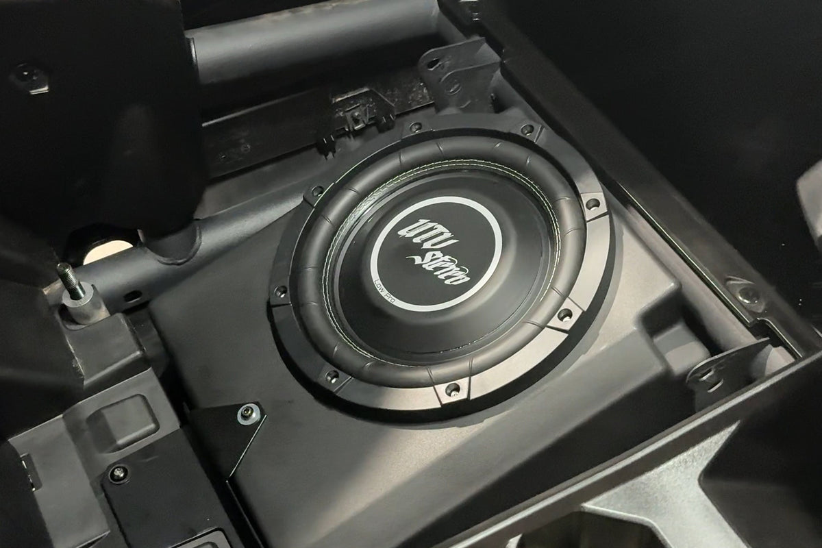 UTV Stereo subwoofer mounted in a vehicle enclosure