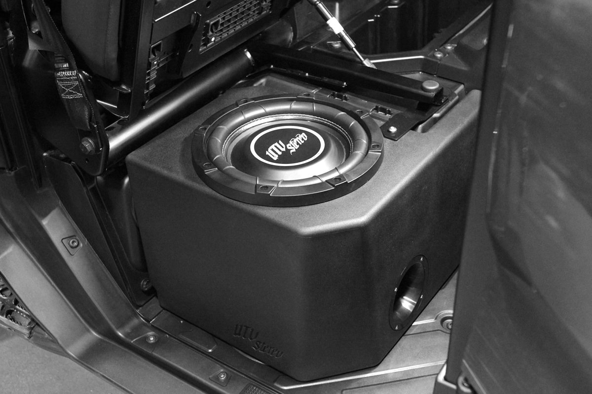 UTV Stereo subwoofer enclosure installed under a vehicle seat