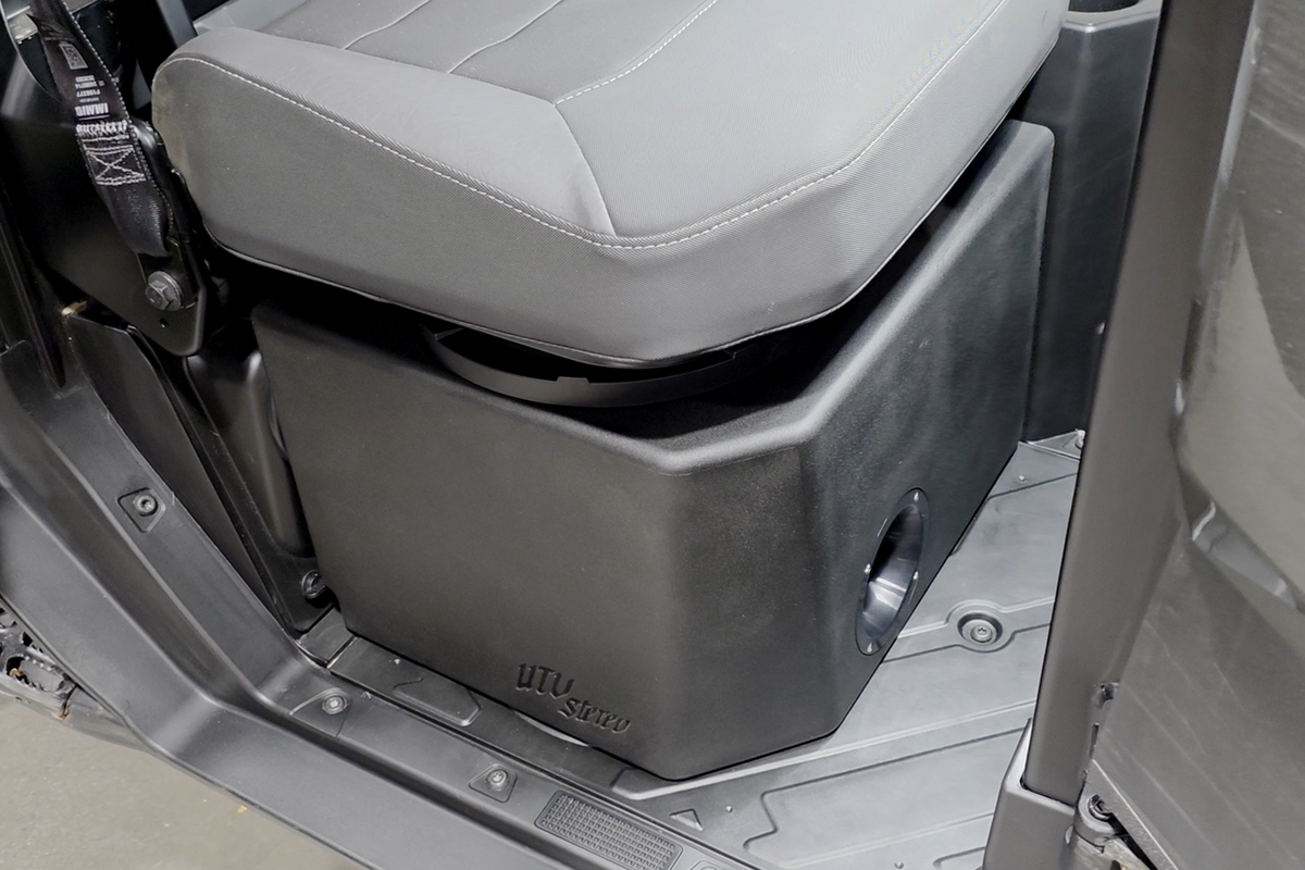 UTV Stereo subwoofer enclosure installed under a vehicle seat